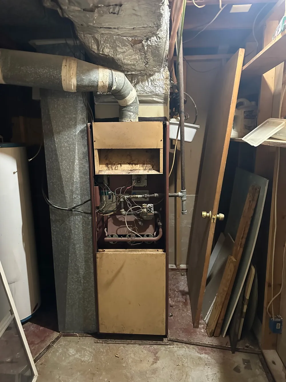 Old furnace in a basement before replacement