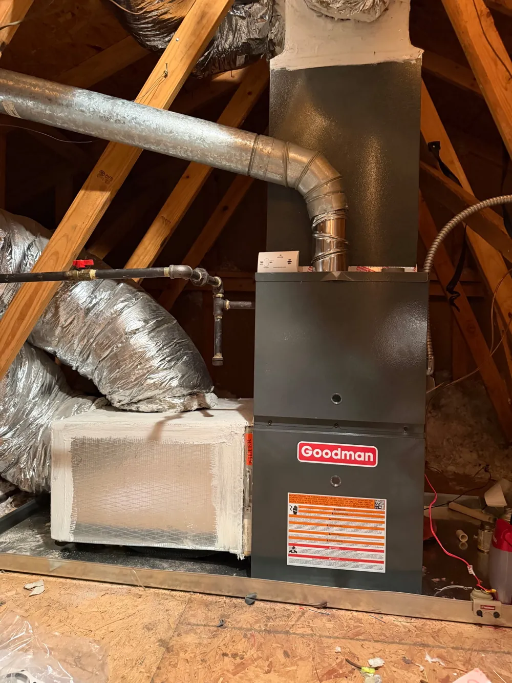 Goodman gas furnace installed in an attic with insulated ductwork